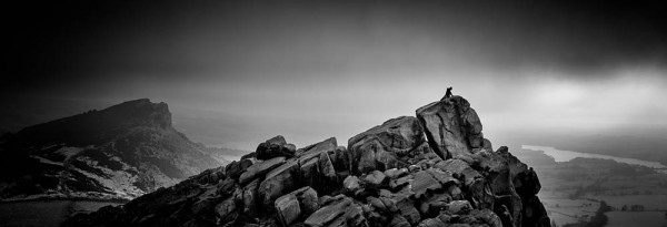 Climber on a rock edge in The Roaches.